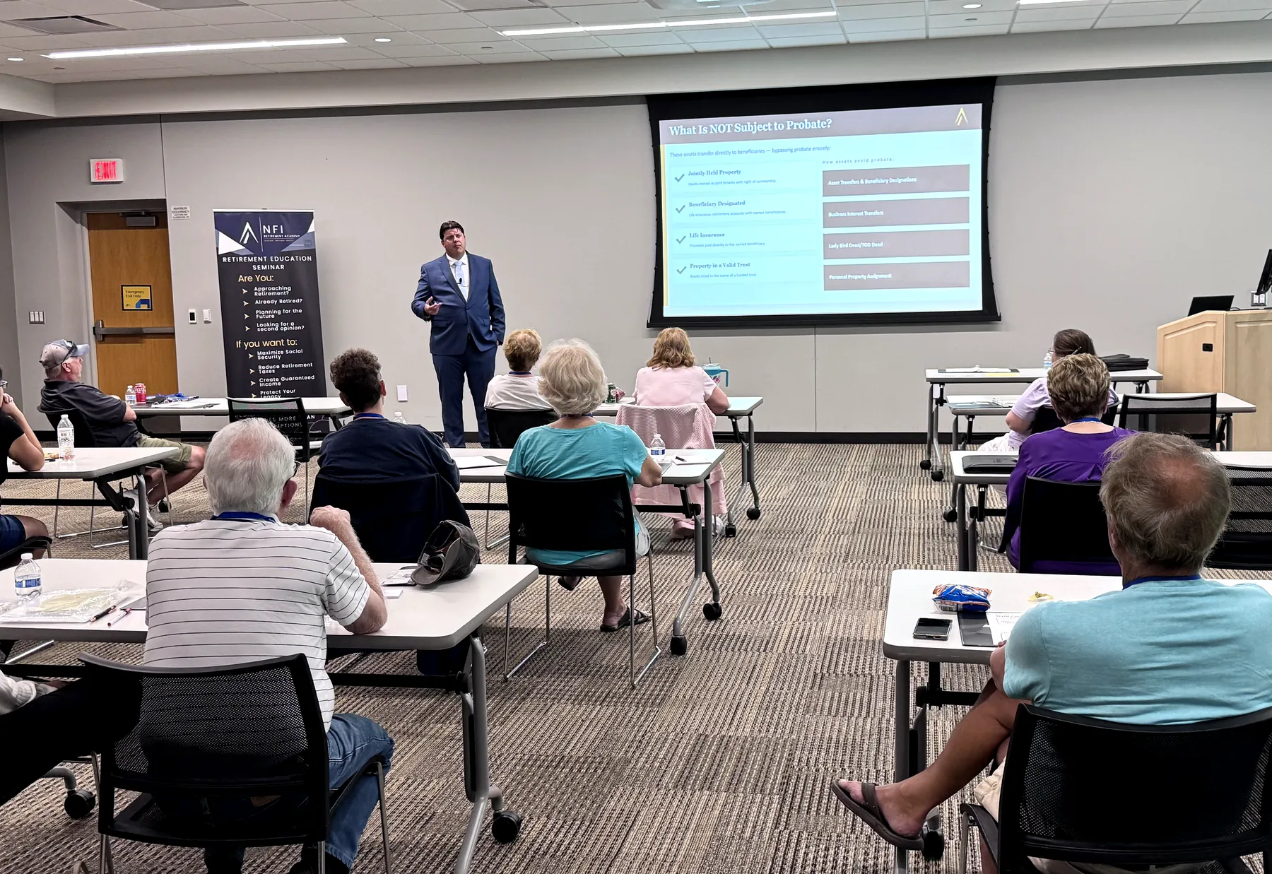 Presenter teaching at an NFI Retirement Academy educational seminar with attendees seated in the room.