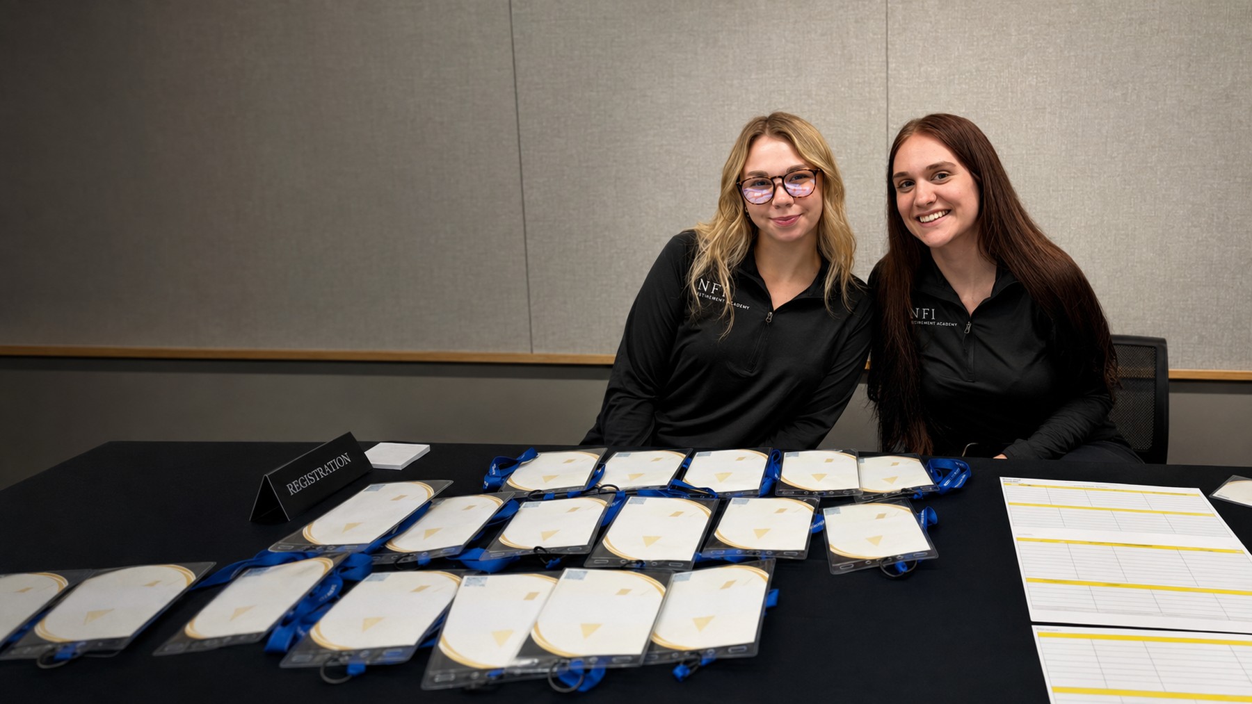 Two people supporting an NFI Retirement Academy event at the registration table