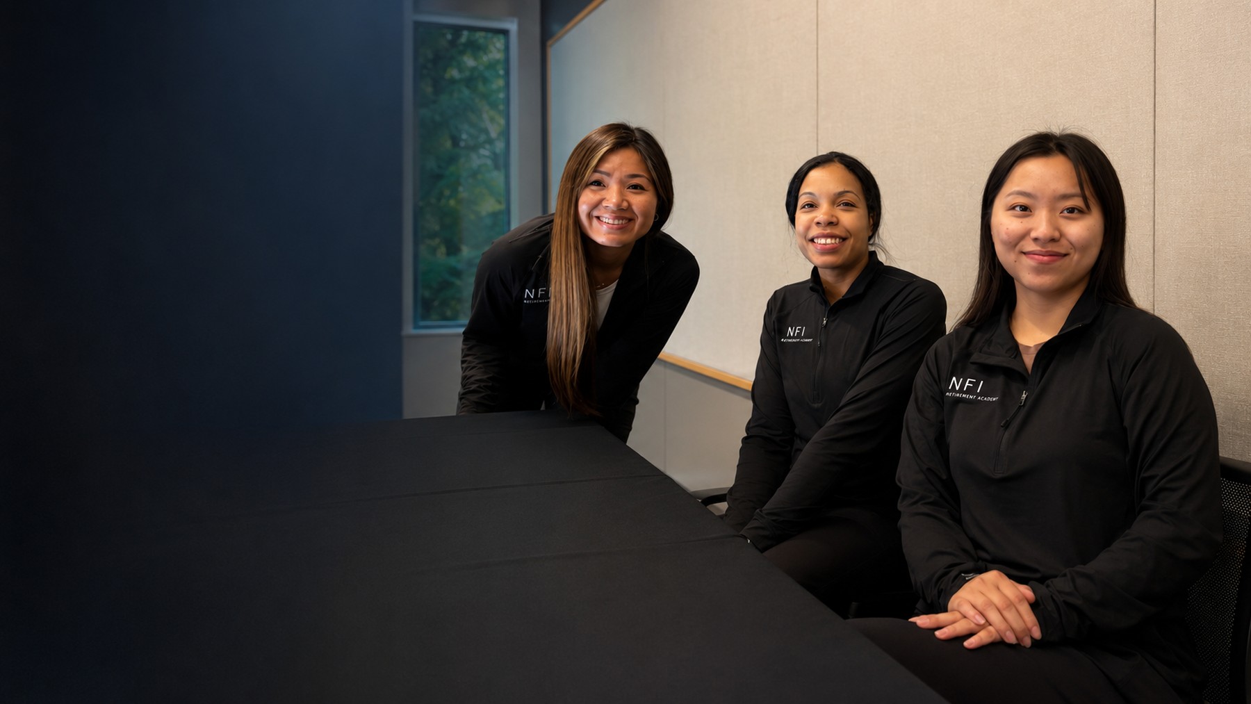Three people supporting an NFI Retirement Academy event